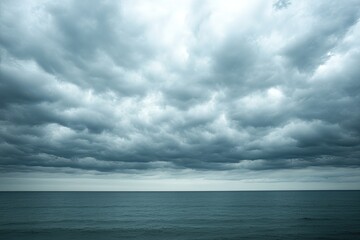 Overcast sky with thick, grey clouds covering the entire horizon, creating a moody and calm atmosphere