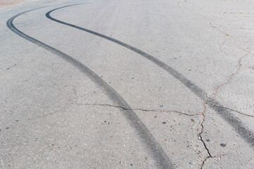 Black traces of car braking on the asphalt. Close-up of skid marks on the road.