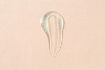 Smear of cosmetic product on beige background, top view