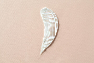 Smear of cosmetic product on beige background, top view