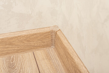 Plastic inner corner of the floor skirting board