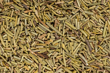 Background macro dried rosemary leaves top view, seasoning texture.