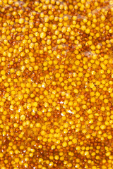 French Dijon mustard background, close-up, top view.
