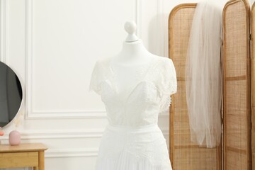 Beautiful wedding dress on mannequin in boutique