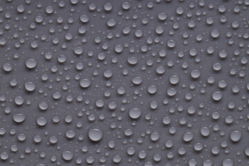 Water drops on gray background, top view