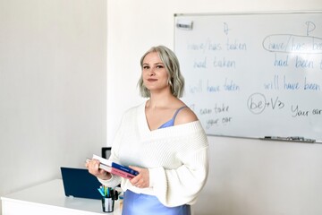 English tutor at a computer in the classroom. Concept of learning foreign languages.