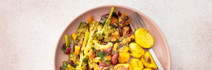 Stewed potatoes with stewed vegetables, broccoli and beans with carrots and herbs, a delicious hearty lunch or dinner, banner