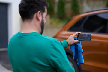 Capturing the Moment: A Man Photographs His Car for Sale to Share Online