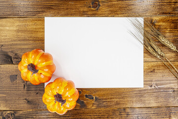 white sheet on wood and halloween pumpkin