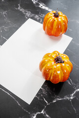 white sheet on black marble and halloween pumpkin