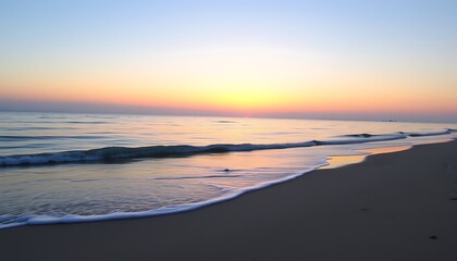 A tranquil stock photo of an empty beach with gentle waves lapping against the shore at sunset.	
