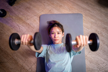 Asian man and woman working out, one is a trainer, the other is an exerciser