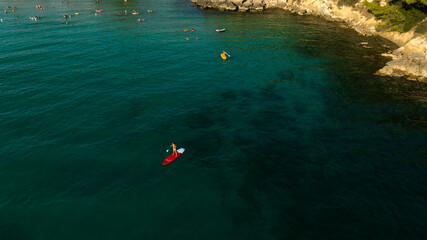 Aerial view of people surfing on a sup in the Mediterranean Sea.