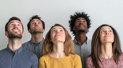 Fototapeta premium Diverse group of adults looking upwards with curiosity and wonder, indoors