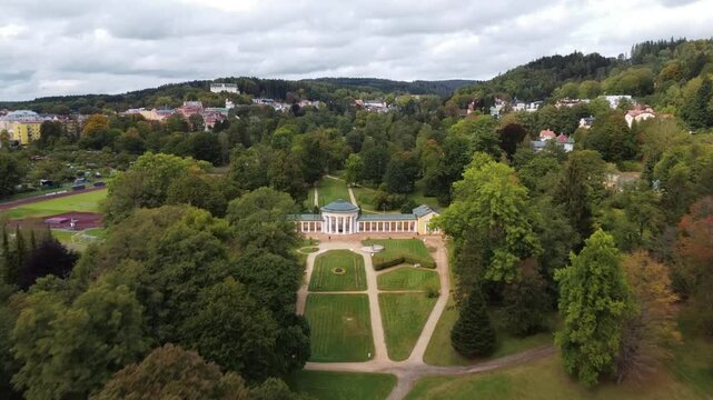 Czech spa town Marianske Lazne (Marienbad) - drone flight through the spa park from the pavilion of Rudolf Spring to the small colonnade of Ferdinand Spring