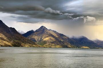 view from Lake Wakatipu to the Walter Peak with dramatic sky in Queenstown, New Zealand