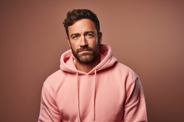 Fototapeta premium Portrait of a blissful man in his 30s sporting a comfortable hoodie isolated in pastel or soft colors background