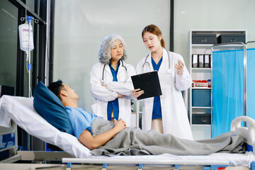 Obraz premium Hospital Ward Male and Male Professional Asian Doctors Talk with a Patient, Give Health Care Advice,