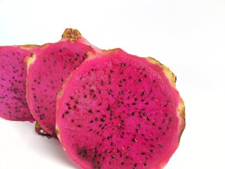 Slices of fresh Dragon fruit on a white background