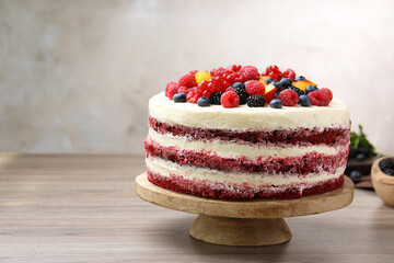 Tasty sponge cake with different fruits on wooden table