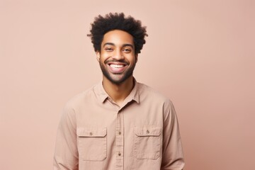 Obraz premium Portrait of a joyful afro-american man in his 20s sporting a breathable hiking shirt over pastel or soft colors background