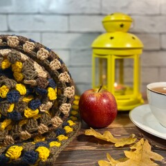 Cozy autumn photo with cup of tea and candle and flashlight and crochet blanket fall vibe mood 