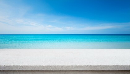 Fototapeta premium Concrete table top against the background of the sea on the beach. Empty white countertop for product presentation with blue water and sky. Outdoor mockup