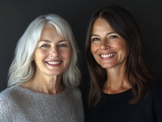 Smiling portrait of two women from different generations, standing next to each other, their facial expressions showing warmth and connection