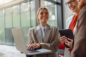 A group of professionals are engaged in a collaborative dialogue in a modern office environment,...