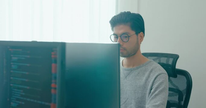 Young adult Asia male freelance eyeglasses typing write prompt AI bot IT app smart program nomad, video game, terminal with coding, user interface, designer, big data center on desktop computer.