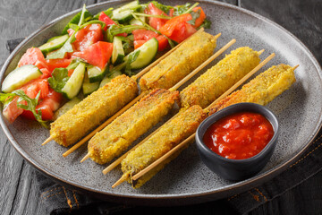 Delicious Breaded Eggplant Sticks with Cheese Served with Vegetable Salad and Tomato Sauce Close-up on Plate on Wooden Table. Horizontal