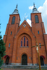 The Catholic church. The old red brick church. A historical building with a religious purpose.