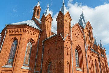 The Catholic church. The old red brick church. A historical building with a religious purpose.