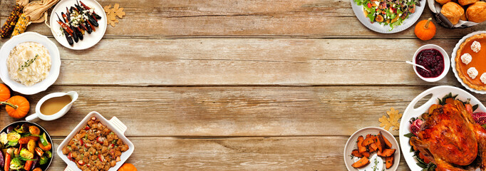 Thanksgiving turkey dinner. Top down view double border on a rustic wood table banner background....