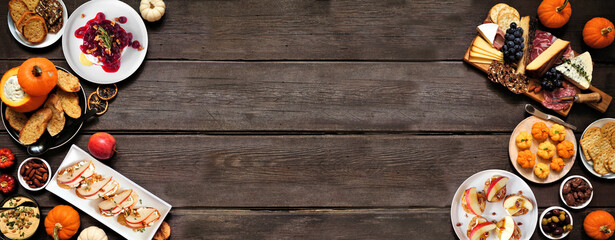 Autumn theme appetizer double border against a dark wood banner background. Charcuterie board, pumpkin and apple dips, crostini, cheeses and snacks. Top down view.