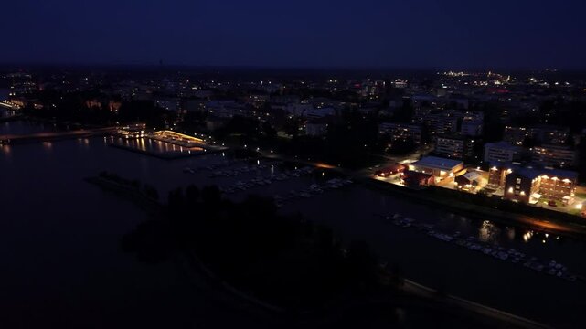 Night-time aerial flying along the Vaasa city waterfront in September, in Finland
