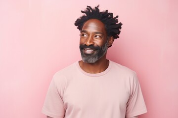 Obraz premium Portrait of a glad afro-american man in his 40s donning a trendy cropped top in solid pastel color wall