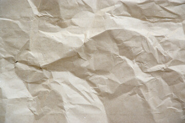 Craft crumpled paper, cardboard background. Brown kraft sheet texture, torn antique page, wallpaper or parchment abstract design, Horizontal rough carton