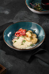 Gourmet Grilled Scallops with Roasted Peppers and Creamy Sauce in Stylish Blue Bowl