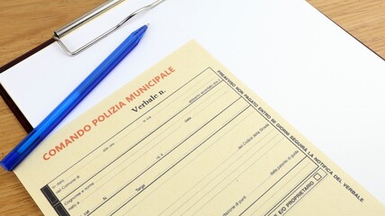 Traffic fine violation Police offence in Italy, form in office and copy space.
