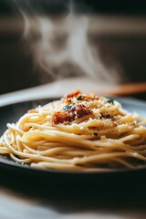 Fototapeta premium Steaming plate of spaghetti carbonara with parmesan cheese and bacon.