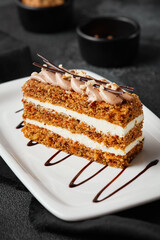 Delicious Carrot Cake Slice with Cream Cheese Frosting on Elegant White Plate