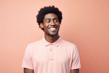 Fototapeta premium Portrait of a cheerful afro-american man in his 20s wearing a breathable golf polo isolated on solid pastel color wall