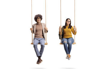 Young man and woman with glasses sitting on wooden swings