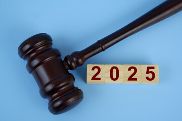 Judge gavel and numbers 2025 on wooden cubes. Concept of court in year 2025.	