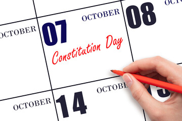 October 7. Hand writing text Constitution Day on calendar date. Save the date.