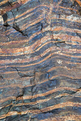 The texture of granite stone with cracks and stripes, made in various shades of brown
