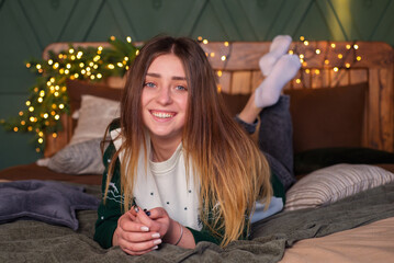 Young happy woman at Christmas at home