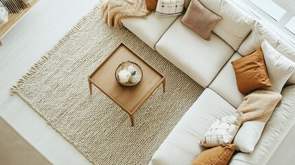 Overhead shot of a cozy living room featuring a sectional couch, throw pillows, and a chic coffee table, set against a clean white backdrop.