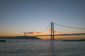 [HYOGO]Sunset view of Akashi Kaikyo Bridge, known as one of the world's largest suspension bridges, The faint orange sunset sky is beautiful, Azur Maiko, Japan